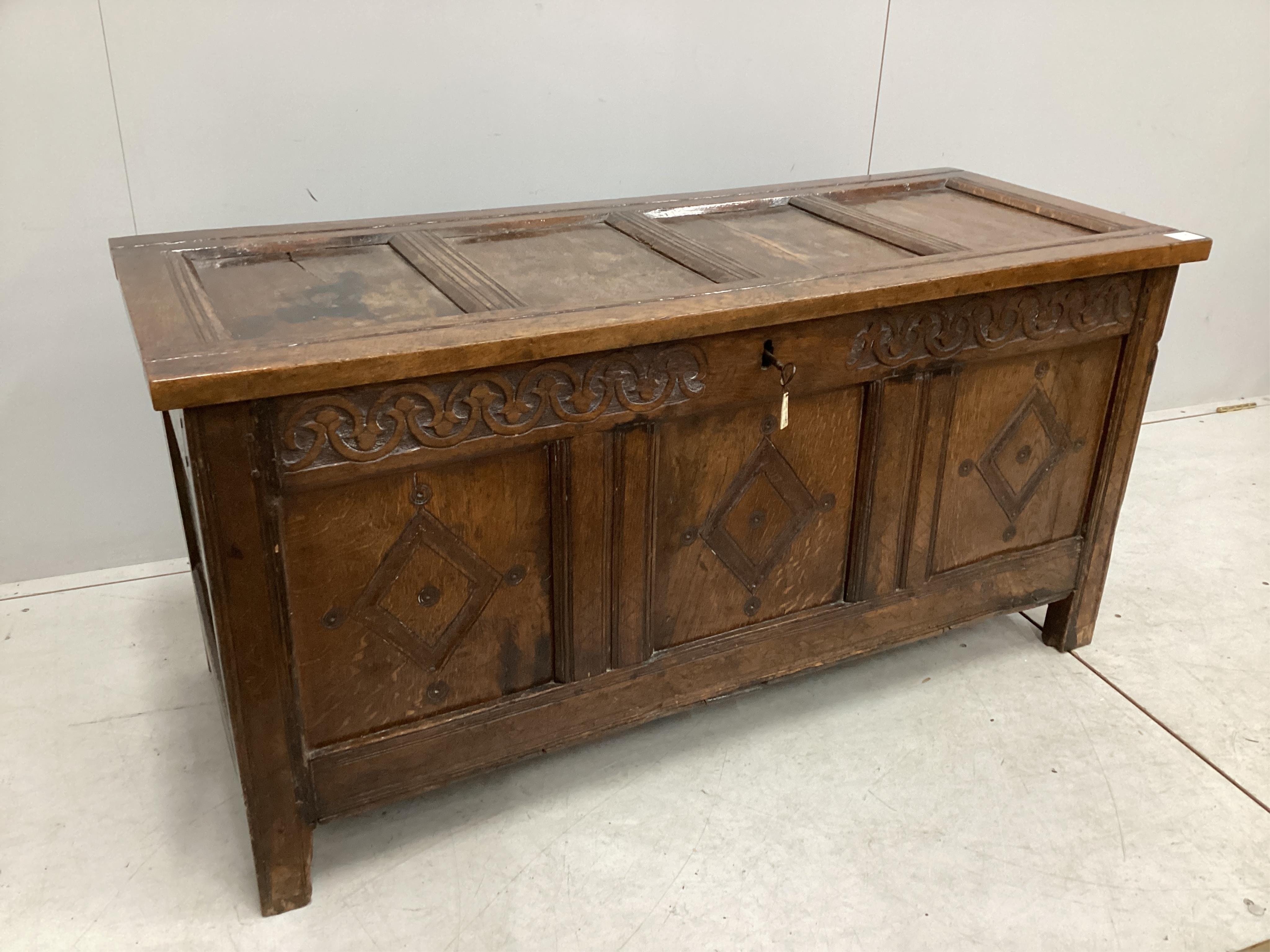 A late 17th / early 18th century panelled oak coffer, width 126cm, depth 51cm, height 62cm. Condition - fair, one top panel split, front probably later carved.